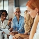 Happy business woman working together online on a tablet